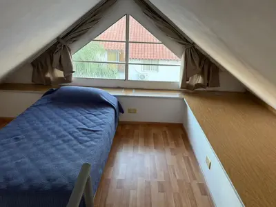 a room with a bed and a large window at Costalago in Villa Carlos Paz