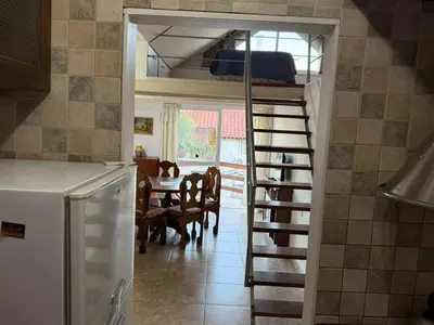 a kitchen with a staircase leading to a dining room at Costalago in Villa Carlos Paz