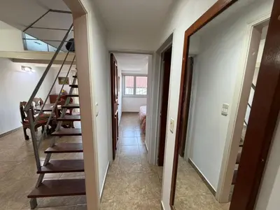 a hallway with stairs leading to a room at Costalago in Villa Carlos Paz