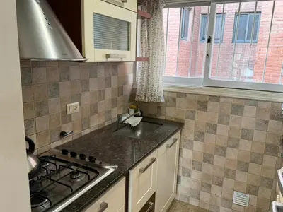 a kitchen with a stove and a counter top at Costalago in Villa Carlos Paz