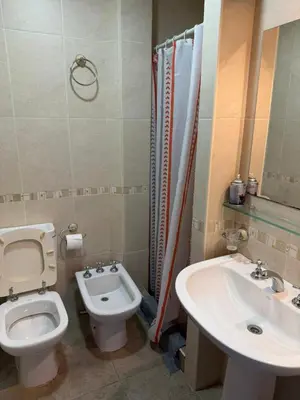 a bathroom with a toilet and a sink at Costalago in Villa Carlos Paz
