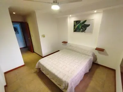 a bedroom with a bed and a picture on the wall at Dpto Eiffel Nueva Córdoba in Cordoba
