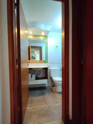 a bathroom with a sink and a toilet and a mirror at Dpto Eiffel Nueva Córdoba in Cordoba