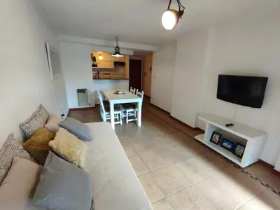 a living room with a white couch and a table at Dpto Eiffel Nueva Córdoba in Cordoba