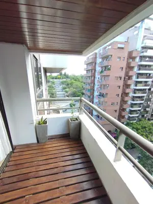 a balcony with wooden flooring and views of buildings at Dpto Eiffel Nueva Córdoba in Cordoba
