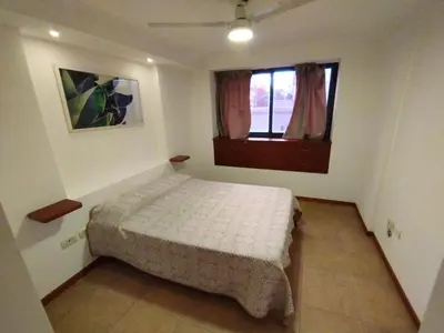 a small bedroom with a bed and a window at Dpto Eiffel Nueva Córdoba in Cordoba