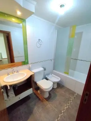 a bathroom with a sink and a toilet and a mirror at Dpto Eiffel Nueva Córdoba in Cordoba