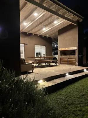 a patio with a table and a couch and a bench at Casa La Loma in Los Reartes