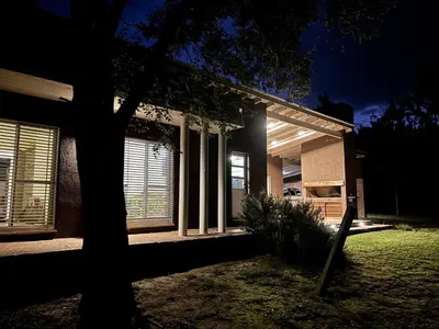 a house with a tree in front of it at night at Casa La Loma in Los Reartes