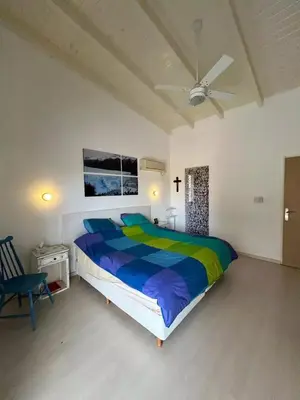 a bedroom with a large bed with a colorful comforter at Casa La Loma in Los Reartes