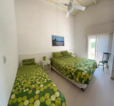 a bedroom with two beds and a window at Casa La Loma in Los Reartes