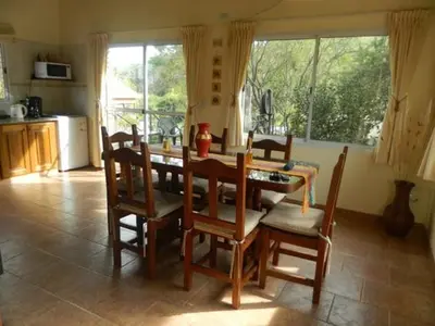 a dining room with a table and chairs in a kitchen at Loszorritos in Merlo