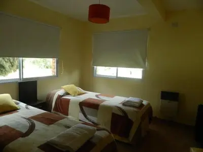 a bedroom with two beds and two windows at Loszorritos in Merlo