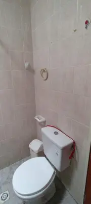 a bathroom with a white toilet in a room at Mi casita de la suerte in Villa Cura Brochero