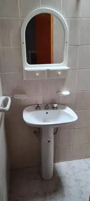 a bathroom with a white sink and a mirror at Mi casita de la suerte in Villa Cura Brochero