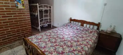 a bedroom with a bed and a brick wall at Mi casita de la suerte in Villa Cura Brochero