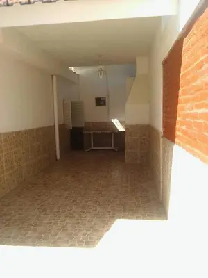 an empty room with a brick wall and a tile floor at Mi casita de la suerte in Villa Cura Brochero