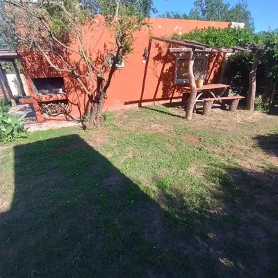a yard with a picnic table and a building at Cabañas Juan in Arroyo de Los Patos