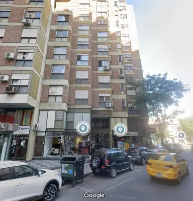 a tall building with cars parked in front of it at Gran Ubicacion Centro in Cordoba