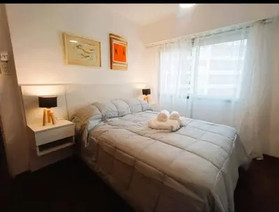 a bedroom with a bed with a stuffed animal on it at Gran Ubicacion Centro in Cordoba