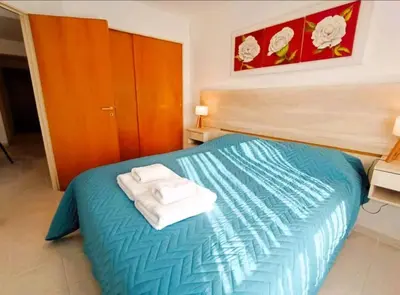 a bedroom with a blue bed with two towels on it at Gran Ubicacion Nueva Cordoba in Cordoba