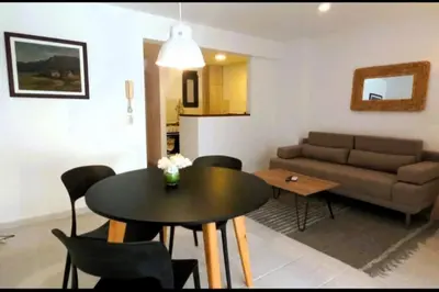 a living room with a table and a couch at Gran Ubicacion Nueva Cordoba in Cordoba