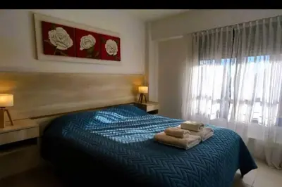 a bedroom with a bed with two towels on it at Gran Ubicacion Nueva Cordoba in Cordoba