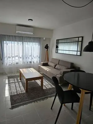 a living room with a couch and a table at Gran Ubicacion Guemes in Cordoba