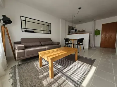 a living room with a couch and a table at Gran Ubicacion Guemes in Cordoba