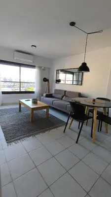 a living room with a couch and a table at Gran Ubicacion Guemes in Cordoba