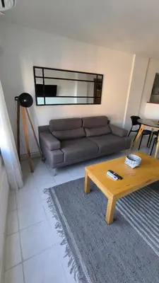 a living room with a couch and a coffee table at Gran Ubicacion Guemes in Cordoba