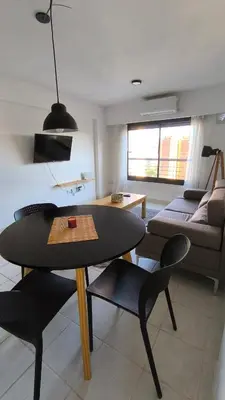 a living room with a table and chairs and a couch at Gran Ubicacion Guemes in Cordoba