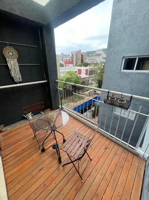 a deck with a table and chairs on a balcony at Depto carlos paz in Villa Carlos Paz