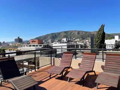 a group of chairs sitting on top of a roof at DEPARTAMENTO EN ALQUILER TEMPORAL Ubicado en Villa Carlos Paz in Villa Carlos Paz