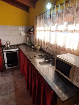 a kitchen counter with a sink and a microwave at Paseo por las Nubes in Santa Rosa de Calamuchita