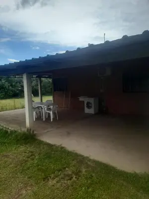 a covered patio with a table and a sink at Cabañas Lo De Elias in San Lorenzo