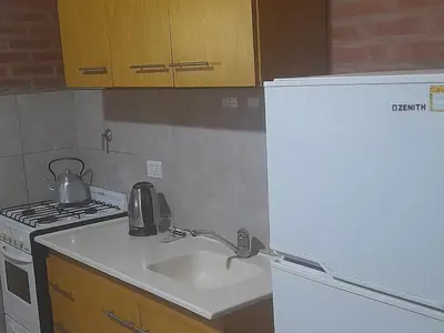 a kitchen with a sink and a stove at Cabañas Lo De Elias in San Lorenzo