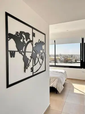 a bedroom with a map of the world on the wall at Luminosos y modernos apartamentos con cochera techada in Cordoba