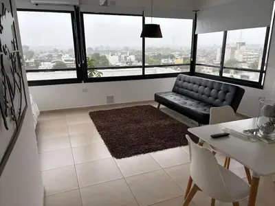a living room with a couch and a table at Luminosos y modernos apartamentos con cochera techada in Cordoba