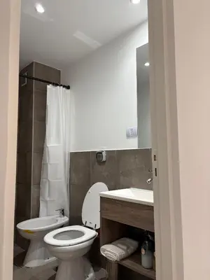 a bathroom with a toilet and a sink at Luminosos y modernos apartamentos con cochera techada in Cordoba