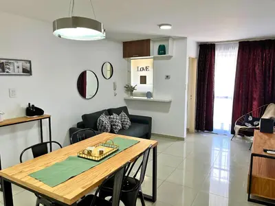 a living room with a table and a couch at Disfruta Córdoba en un departamento premium! in Cordoba
