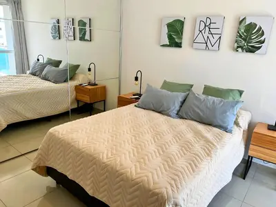 a bedroom with two beds and paintings on the wall at Disfruta Córdoba en un departamento premium! in Cordoba