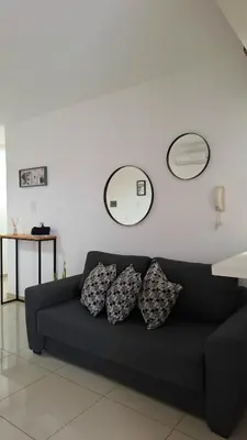 a black couch with three pillows in a living room at Disfruta Córdoba en un departamento premium! in Cordoba