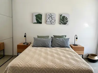 a bedroom with a bed with three pictures on the wall at Disfruta Córdoba en un departamento premium! in Cordoba