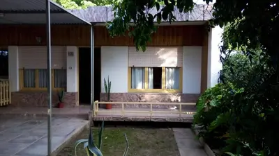 a house with a bench in front of it at Casa Abuela Tere in Santa Rosa de Calamuchita