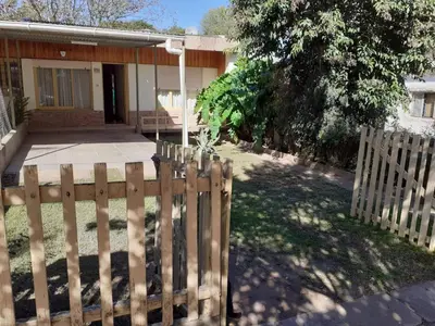 a wooden fence in front of a house at Casa Abuela Tere in Santa Rosa de Calamuchita