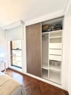 a bedroom with white walls and a closet with shelves at Nueva Córdoba - Ituzaingó Siglo 21- Sanatorio Allende in Cordoba