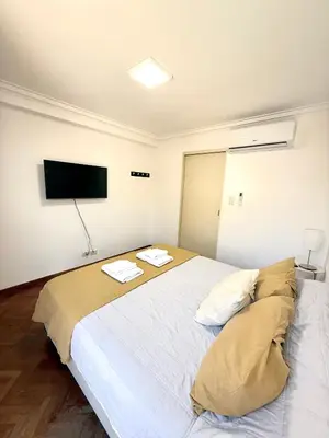 a bedroom with a large bed with two towels on it at Nueva Córdoba - Ituzaingó Siglo 21- Sanatorio Allende in Cordoba