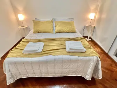a bedroom with a large bed with two lamps at Nueva Córdoba - Ituzaingó Siglo 21- Sanatorio Allende in Cordoba