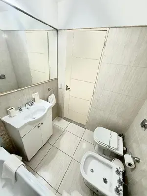 a bathroom with a sink and a toilet and a mirror at Nueva Córdoba - Ituzaingó Siglo 21- Sanatorio Allende in Cordoba